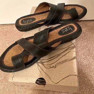 Black B.O.C by Born leather sandals with strap on toe design.
